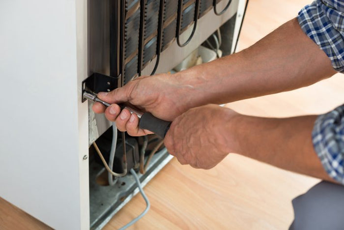 Repair technician working on an appliance