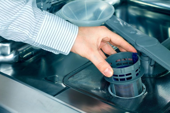 Repair technician inspecting a dishwasher spout funnel